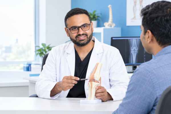 Dr. Mitul Patel consulting a patient at Boneplus Hospital in Ahmedabad